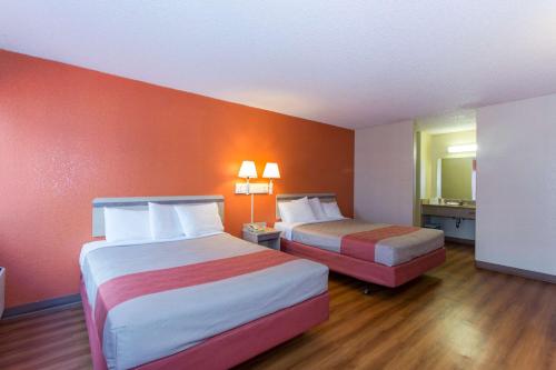 a hotel room with two beds and a mirror at Cathedral Hill Hotel in San Francisco