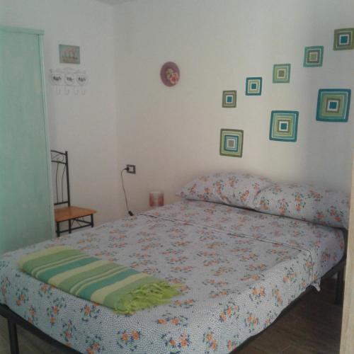 - une chambre avec un lit et des photos sur le mur dans l'établissement Piccolo accogliente monolocale, à Siniscola