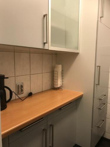 a kitchen with a wooden counter top and a refrigerator at FeWo mit Pool Haus Enere Au in Todtmoos