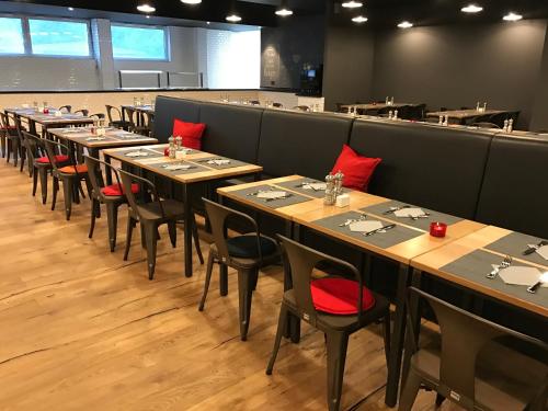 a row of tables and chairs in a restaurant at Best Western Hotel Kaiserslautern in Kaiserslautern