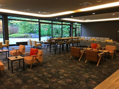 a dining room with tables and chairs and windows at Best Western Hotel Kaiserslautern in Kaiserslautern