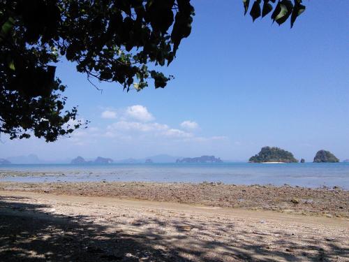 a beach with rocks and islands in the water at Tabeak View Point in Ko Yao Noi
