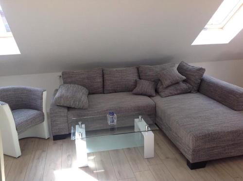 a living room with a couch and a glass table at Haus Irma in Zingst