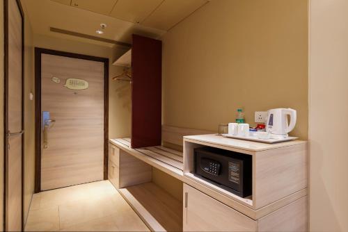 a small kitchen with a microwave on a counter at Pride Elite, Phaltan in Phaltan