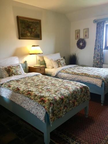 a hotel room with two beds and a couch at Penzion V polích in Malé Číčovice