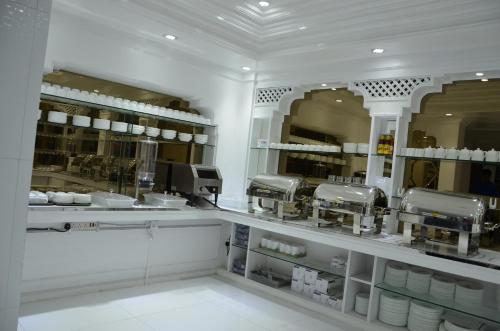 a kitchen with a counter with dishes and coffee machines at White Fort Hotel in Dubai