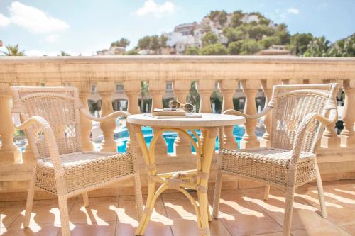 a table and two chairs on a balcony at Mon Port Hotel & Spa in Port d’Andratx