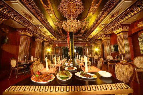 a dining room with a table with dishes of food at Ginger House Museum Hotel in Cochin