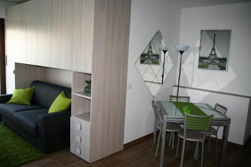 a living room with a table and a couch at Appartamento Morena CIR 0043 in Aosta