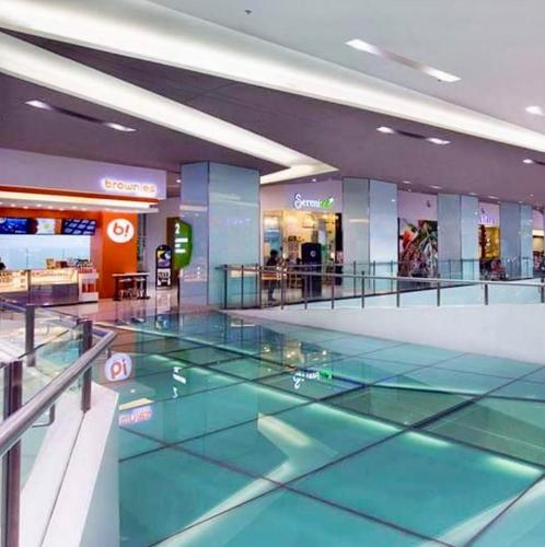 a shopping center with a glass floor in a mall at SMDC Light Residences Condominium in Manila