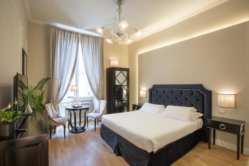 Ένα ή περισσότερα κρεβάτια σε δωμάτιο στο Relais Tosinghi