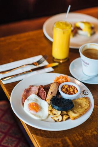 a plate of breakfast food with eggs and bread on a table at Bowfield Hotel and Spa in Howwood