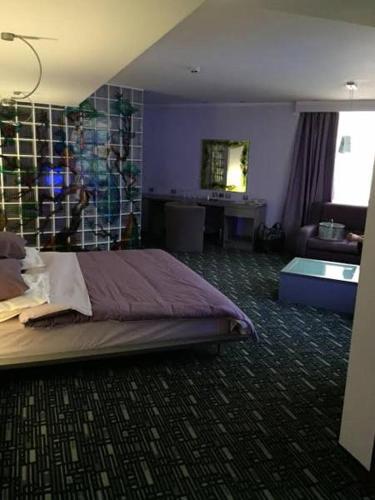 a bedroom with a bed and a living room at Art 'Otel in Sofia