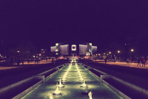 a building with a fountain in front of it at night at Art 'Otel in Sofia