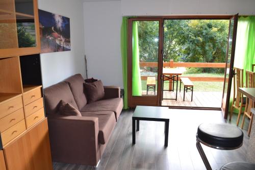 a living room with a couch and a table at Edelweiss Valberg in Valberg