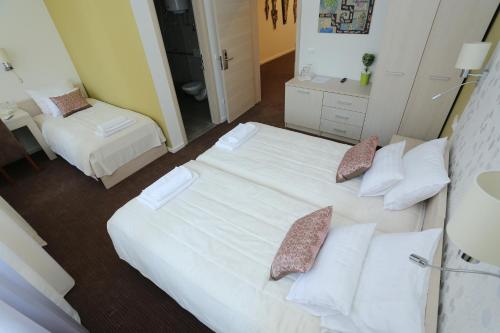 a hotel room with two beds with pillows at Konačište Grad B&B in Užice