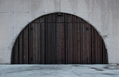 a large wooden door on a concrete wall at Fana Estate in Dobrovo