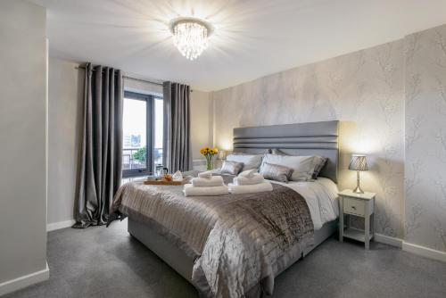 a bedroom with a large bed with towels on it at 134 Baltic Quay in Newcastle upon Tyne