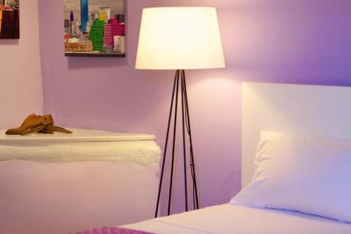 a lamp in a bedroom next to a bed at Blue Paradise in Margarítai