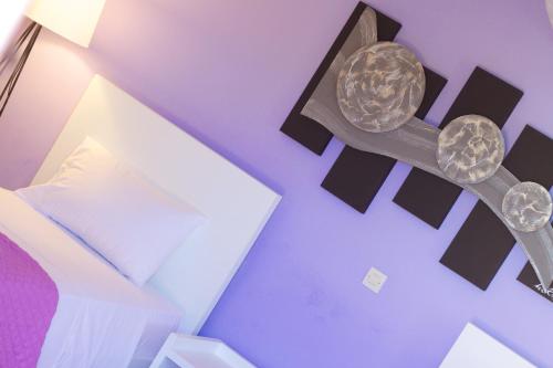 a room with a bed and a lamp on a wall at Blue Paradise in Margarítai