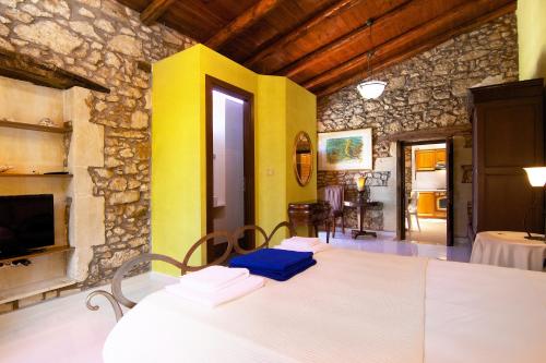 a living room with a table and a yellow wall at Blue Paradise in Margarítai