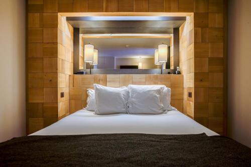 a bedroom with a large bed with a large mirror at Excelsior Chamonix Hôtel & Spa in Chamonix-Mont-Blanc