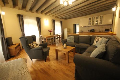 a living room with a couch and chairs and a table at Apartmány Scharffenberg in Banská Štiavnica