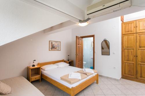 a bedroom with a large bed and a bathroom at Guest House Rajic in Slano