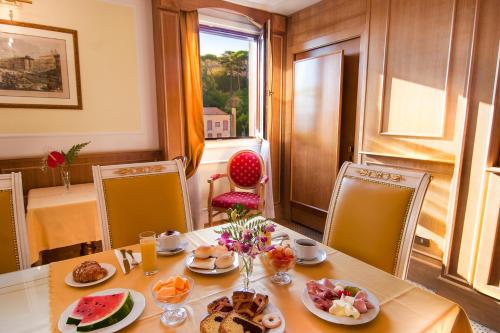 a table with food on it in a room with a window at Residenza Paolo VI in Rome
