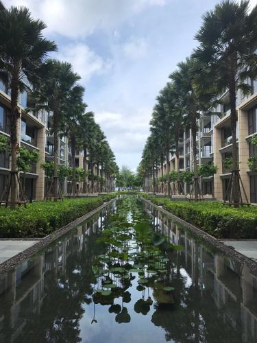 a canal in a city with palm trees at Baan Mai Khao in Mai Khao Beach
