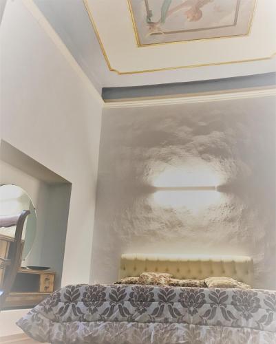 a bedroom with a bed and a painting on the wall at Eleonora Room & Breakfast in Oristano
