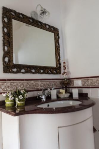 a bathroom with a sink and a mirror at Masseria Luco in Martina Franca
