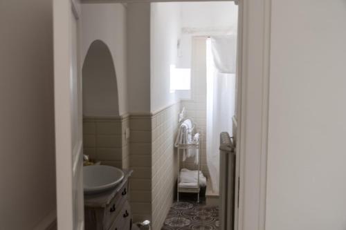 a bathroom with a sink and a toilet and a mirror at Masseria Luco in Martina Franca