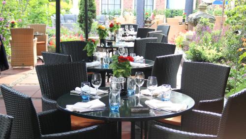 a table with wine glasses and flowers on a patio at Hotel & Restaurant De Fortuna in Edam
