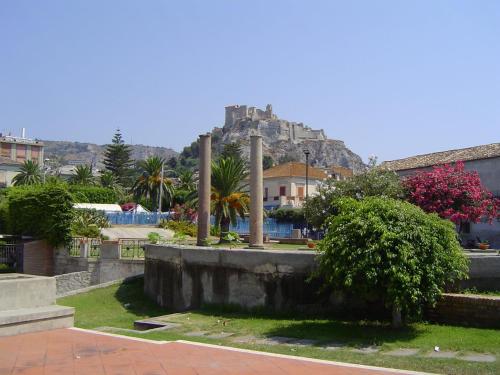 a view of a city with a castle on a hill at Hotel Mediterraneo in Roccella Ionica