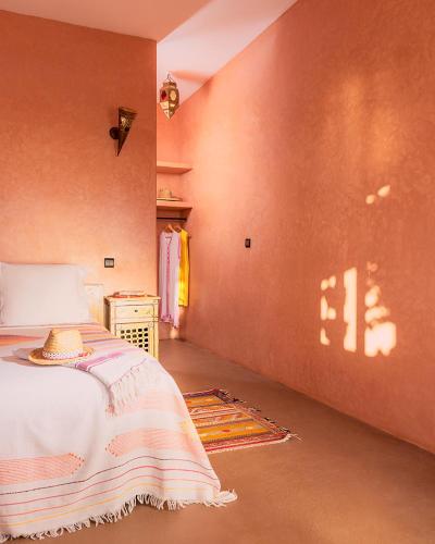 a bedroom with a bed with a hat on it at Aftas Trip in Mirleft