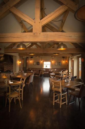 a dining room with wooden tables and chairs at Three Horseshoes Country Inn in Leek