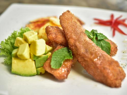 a plate of food with french fries and vegetables at Hotel Buena Vista in Bucaramanga