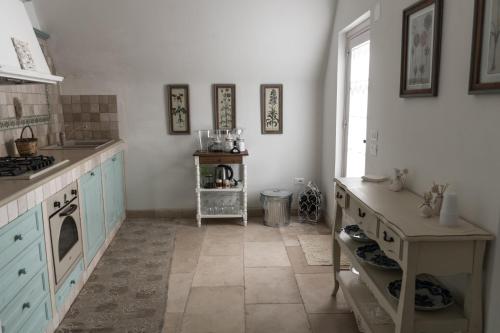 a kitchen with blue cabinets and a stove top oven at Masseria Luco in Martina Franca