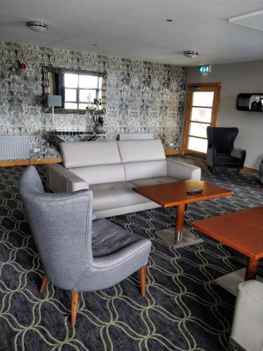 a living room with a white couch and a table at Cromore Halt in Portstewart