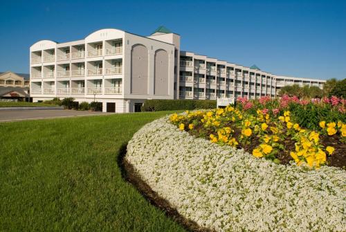 a large building with flowers in front of it at Casa Del Mar Beachfront Suites in Galveston