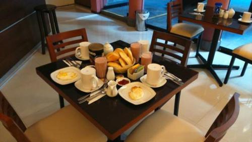 a table with plates of food on top of it at Hostal Qoyllurwasi in Arequipa