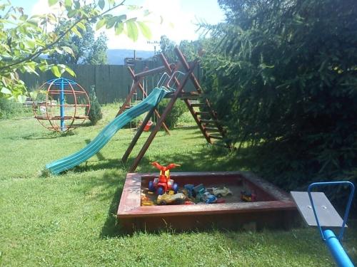 a playground with a slide and toys in a box at U Haryho in Dolní Bečva