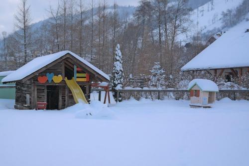 a play house with snow on top of it at Casa Moeciu Family in Moieciu de Jos