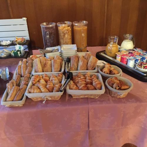 a table topped with trays of pastries on a table at Hostellerie de Pavillon Saint-Hubert in Gouvieux