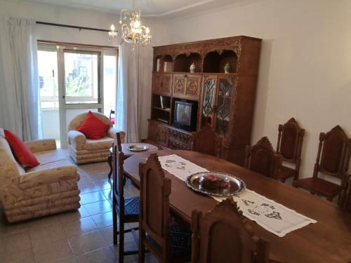 a living room with a wooden table and a dining room at LUCINDA`S HOUSE in Braga