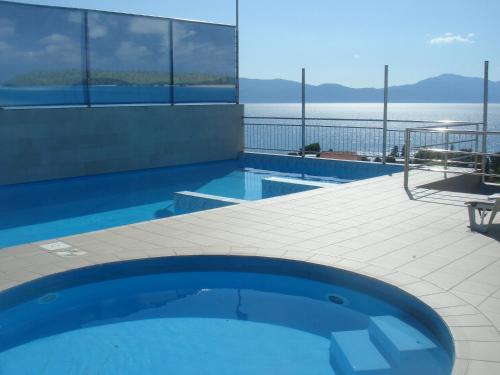 a swimming pool with a view of the water at Aparthotel Pecic in Gradac