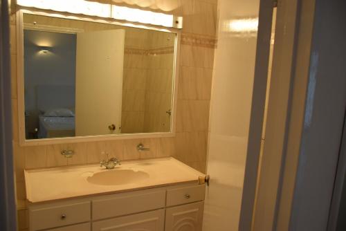 a bathroom with a sink and a mirror at 1 Bed Apartment/Condo in Saint James