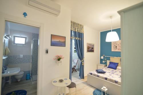 una piccola camera con letto e bagno di Dimora Pascali Holiday - " Home & Relax " a Polignano a Mare