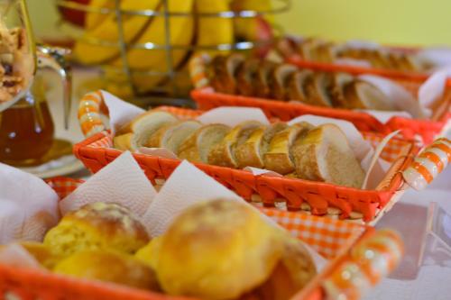 un mucchio di cesti pieni di pane e altri alimenti di Pousada Ágape a Monte Verde
